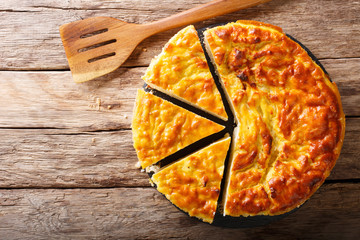 Wall Mural - rice pie with ricotta cheese, eggs and sugar close-up on the table. horizontal top view from above