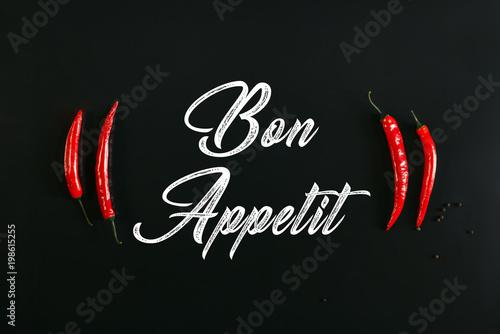 Plakaty do jadalni bon-appetit-inscription-and-red-chili-peppers-on-black
