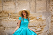 © Елена Кравчук - Woman fun in travel, city ancient, old background, dress blue, straw hat, outdoor, open mouth