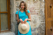 © Елена Кравчук - Beautiful woman holding hat, outdoor, standing on stone street, window, old background
