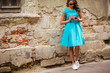 © Елена Кравчук - Young woman holding camera, in dres blue, beautiful on old wall, ancient background, copy space
