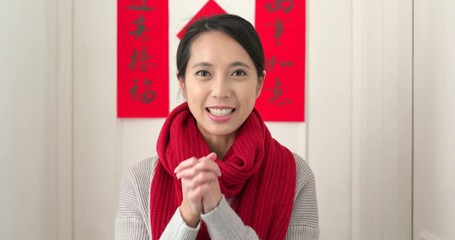 Canvas Print - Chinese woman saying blessing phrase during lunar new year at home