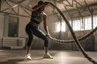 © Jacob Lund - Athlete working out with battle ropes at cross gym