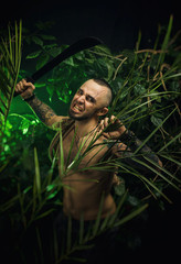 a man in the jungle with machetes attacking the enemy