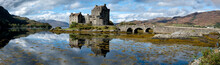 A Panorama Of The Eilean Donan Castle On A Sunny Afternoon In Scotland.