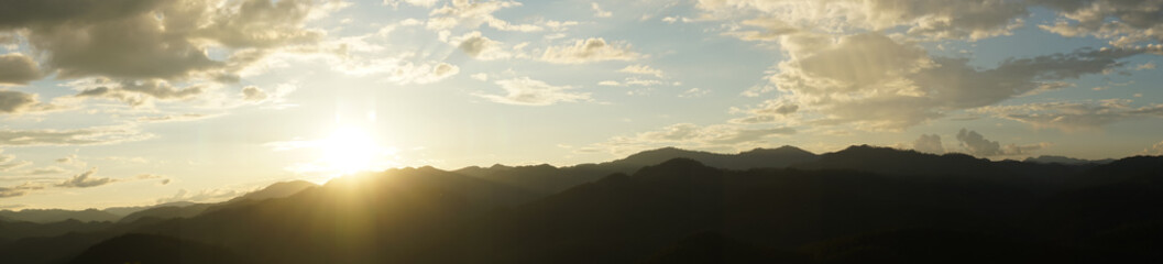 Wall Mural - Amazing wild nature view of layer of mountain forest landscape with cloudy sky when sunset or twilight. Natural green scenery of cloud and mountain slopes background. Maehongson,Thailand