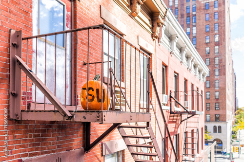 Fotografie, Tablou Chelsea neighborhood brick fire escape apartment buildings, street below in New
