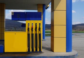 Wall Mural - Gasoline pistols pump gun fuel nozzles dispenser refueling petrol filling station