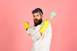 © Svitlana - Cleaning, cleaning service, housekeeping concept - angry bearded man in uniform and rubber gloves holds cleanser spray. Effective cleaning means. Copy space for advertise detergents, cleaning service.