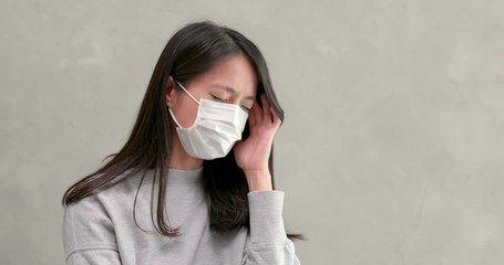 Wall Mural - Woman wearing mask and feeling headache