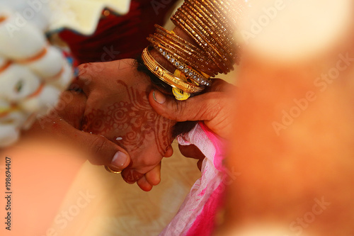 Close Up Of Indian Bride And Groom Holding Hands After The Wedding