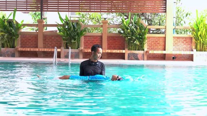 Wall Mural - Father teaches daughter to swim