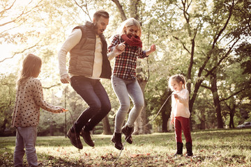 Wall Mural - Cheerful family in park.