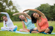 Yoga at park.family couple exercising outdoors. Concept of healthy lifestyle.women exercising in the park.