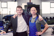 © Firma V - boss and worker on work bench- hugging
