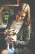 © Mladen - Happy young girl sitting in cafe and holding her pet cat.