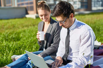 Sticker - Busy young man in formalwear and his colleague looking through online information while preparing for business conference