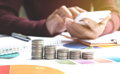 Wall Mural - Man using calculator with stock financial indices with stack coin. Financial stock market in accounting market economy analysis.