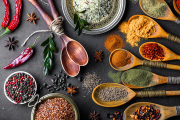 Spices for cooking with kitchen accessories on an old background