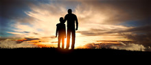 Father And Son At Sunset. Happy Concept Of Parenting And Taking Care Of Children.