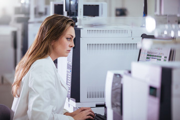 Wall Mural - young woman scientist working with equipment in a laboratory