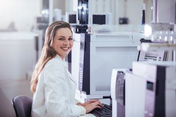 Wall Mural - young woman scientist working with equipment in a laboratory