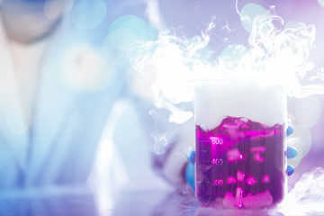 Wall Mural - hands of a scientist moving pink liquid with white smoke in laboratory glassware