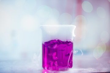 Wall Mural - laboratory glassware with pink liquids and white smoke