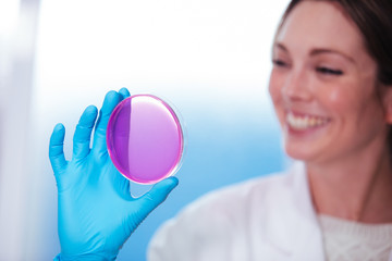 Wall Mural - woman scientist observation about petri dish in laboratory