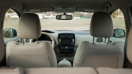 Modern electric car interior. View from back.