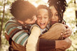 © Mladen - African American family enjoying in hug together in nature.