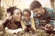 © Mladen - Smiling African American little girl taking self picture in park of parents and her.