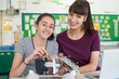 © highwaystarz - Portrait Of Teacher With Female Pupil Studying Robotics In Science Lesson