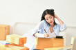 © S photographer - Sme business concept. Young people are packing their packages.Delivery business  Small and Medium Enterprise (SMEs). Young woman is working in the house.Young Owner Start up for Business Online.