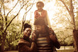 © Mladen - Portrait of African American family in park together.