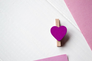 Wall Mural - Decorative pin and pink memo sheet on a white wooden background.