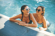 © BGStock72 - Young women having fun by the pool at  summer day