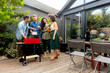 © BGStock72 - Friends grilling food and enjoying barbecue party outdoors