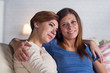 © Anatoly Tiplyashin - Homosexual couple of lesbian women at home on the couch hugging