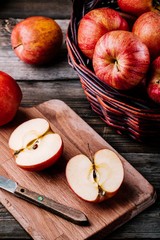 Wall Mural - red ripe apples in a basket on a wooden background