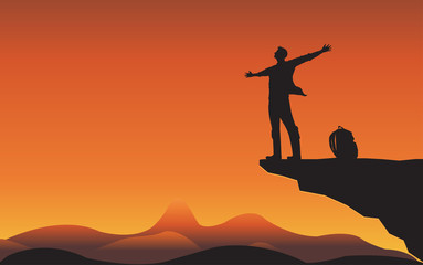 Wall Mural - Sillhouette man on mountain cliff