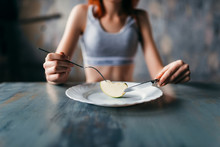 Female Person Against Plate With A Slice Of Apple