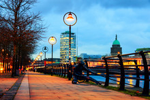 Illuminated Sean O'Casey Bridge With The Custom House In Dublin, Ireland