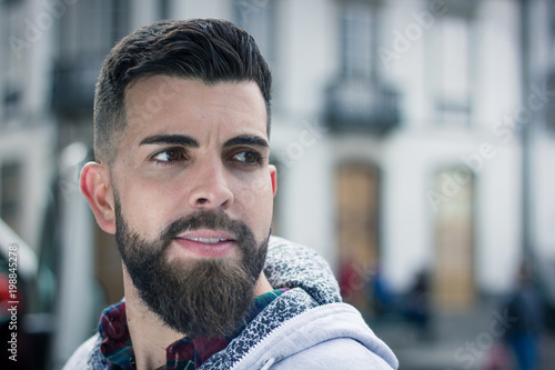 Closeup On Handsome Young Man With Full Beard Outdoors