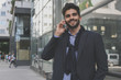 © Mladen - Young businessman using smart phone outdoor.
