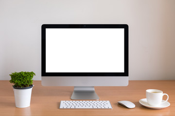 All in one computer, mouse, keyboard and tree vase  on wooden table