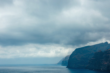 Wall Mural - View of the cloudy cliffs of Los Gigantes in Tenerife, Canary Islands, Spain