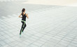 © Prostock-studio - Young woman jogging in city copy space