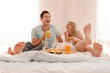 © Africa Studio - Young lovely couple having breakfast on bed