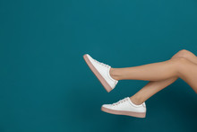 Legs Of Beautiful Woman In Stylish Shoes On Color Background